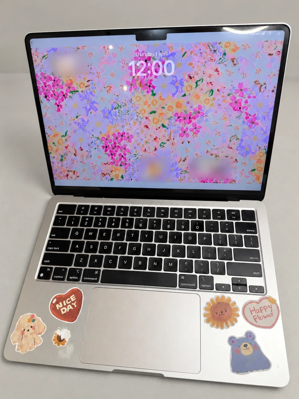 MacBook with a working replacement display; customer account details obscured